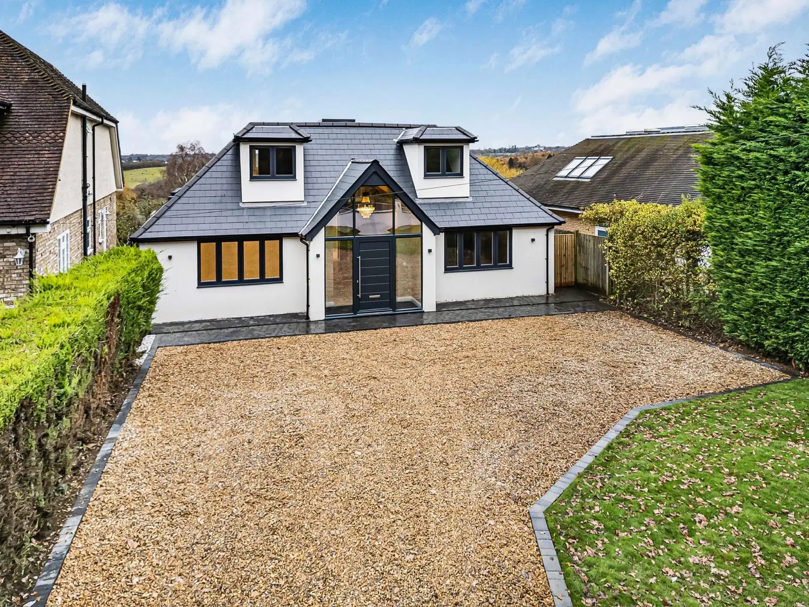 Front exterior of a high-specification new build with gravel driveway, Hertfordshire
